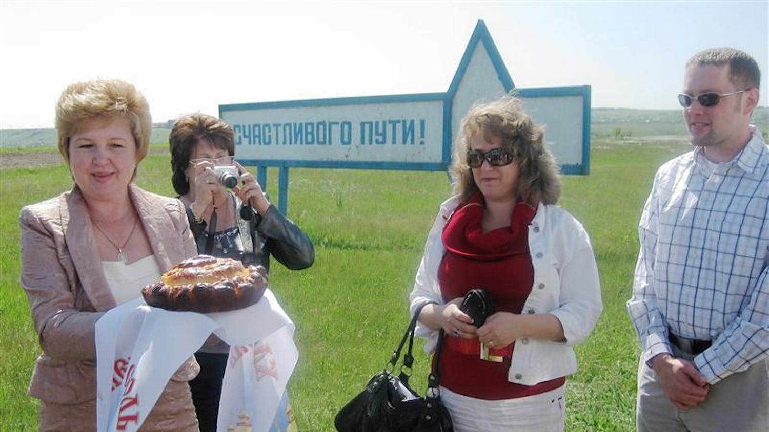 Two directors (left) of a regional hospital near Azov, Russia, present IUPUI adjunct professor Natalia Rehkter and IUPUI nursing student Gavyn Ryan a symbolic loaf of bread May 21, 2009. The bread was baked by the doctors and nurses of the hospital to welcome their first American guests.
