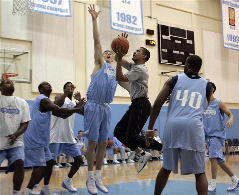 Then Democratic presidential hopeful Sen. Barack Obama, center right, driving to the basket against the University of North Carolina's Tyler Hansbrough during a game April 29 in Chapel Hill, N.C.