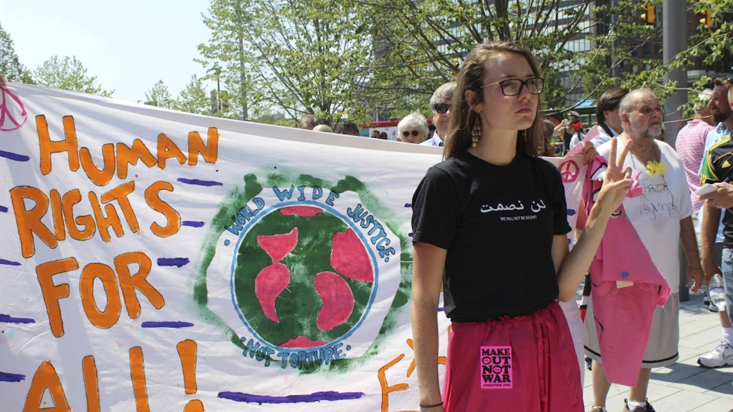 Code Pink activist Chelsea Byers stands in Public Square in Cleveland, OH, sporting a "Make Out Not War" sticker on her pink pants. The group opposes the U.S. war on Iraq and often uses satirical and theatrical tactics to deliver its message for peace.