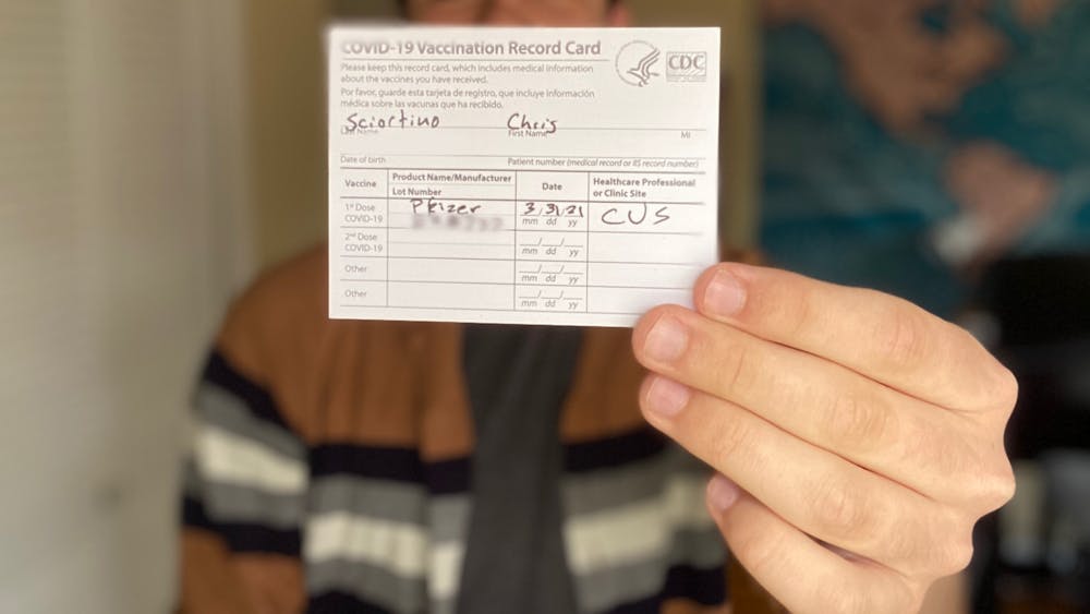 Indiana Daily Student columnist Chris Sciortino holds his COVID-19 vaccination record card March 31. Indiana&#x27;s eligibility requirement expanded Wednesday to include everyone 16 years and older. 