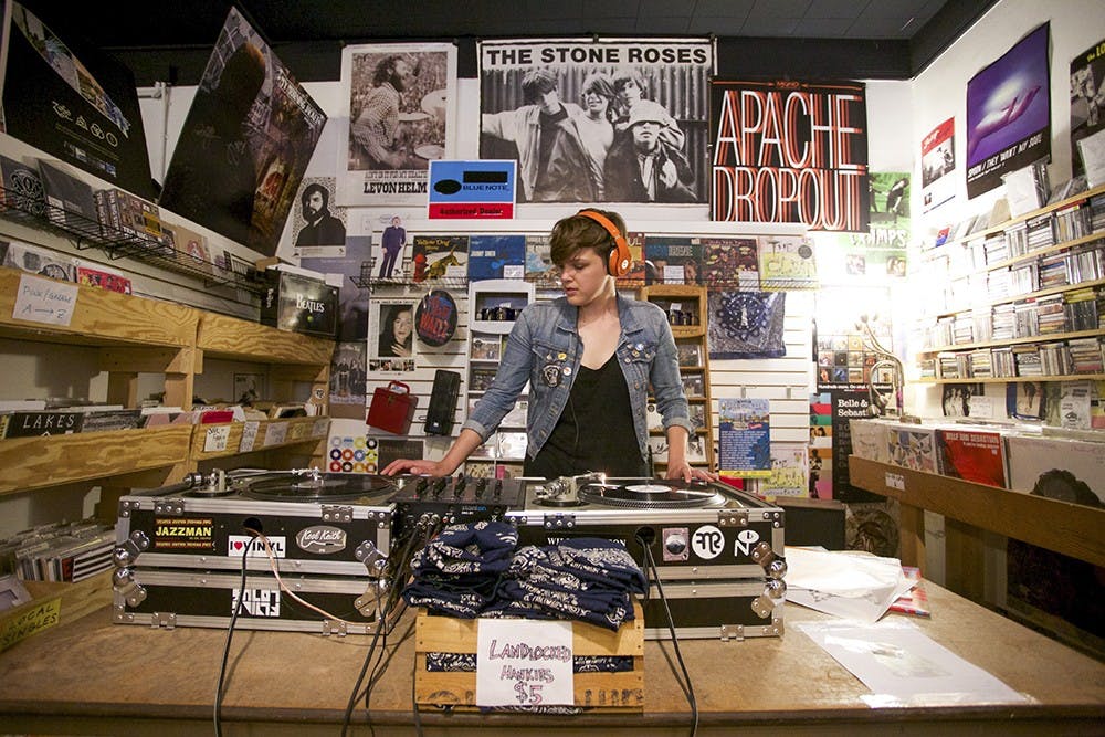 DJ Ann Jonker plays LPs on April 19, 2015, during the Record Store Day celebration at Landlocked Music. The store will celebrate Record Store Day on April 13 with live music and exclusive vinyl releases. ﻿