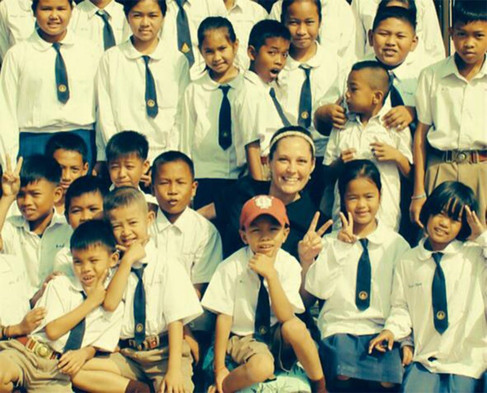 IU alum Jenny Wininger with a group of children in Thailand. Wininger is currently teaching English in Thailand. 
