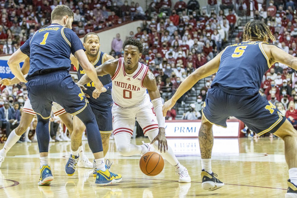 <p>Senior guard Xavier Johnson drives against the Michigan defense on Saturday at Simon Skjodt Assembly Hall. Johnson scored 14 points during the game against Michigan. </p>