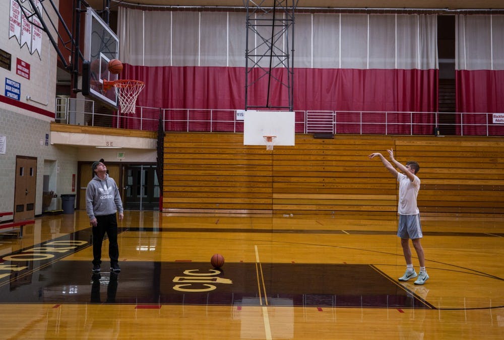<p>Ted Brown, left, rebounds free throws for his son, Luke Brown, at an early morning practice at Blackford High School in Hartford City, Indiana. Luke, originally from Brownsburg, Indiana, came to Blackford because of the head coach, Jerry Hoover.</p>