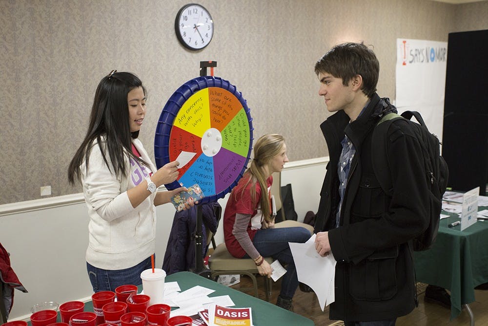 Junior Zach Osborn plays question and answer board about consent in an interactive awareness event for domestic violence at IMU. 