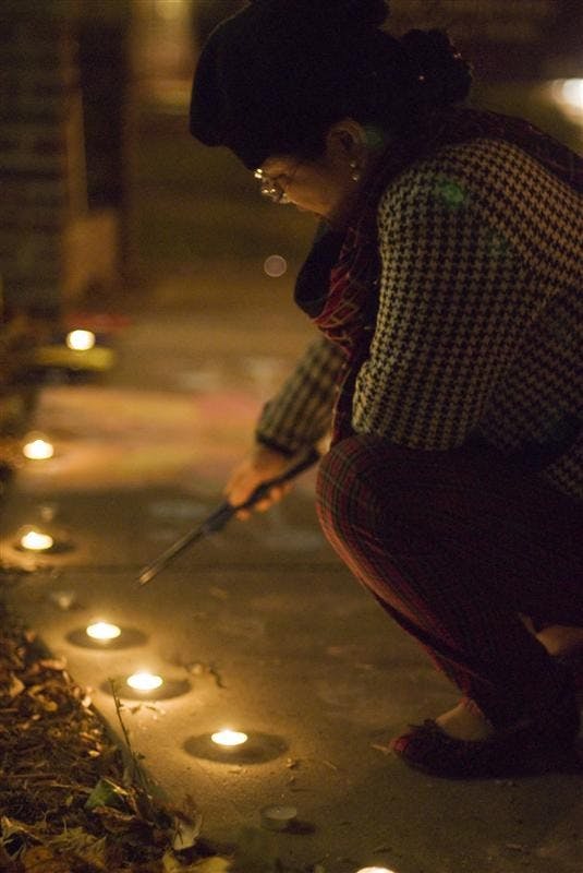 Administrative assistant of the Asian Culture Center, HaeSook Park lights candles in celebration of Divali, the Indian festival of light Thursday night outside the AAC's building. The candle lighting followed dance demonstrations at Mathers Museum and outside the AAC, and free Indian food for attendees. 