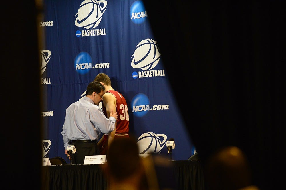 Head coach Tom Crean and sophomore Collin Hartman leave the stage after IU's post game press conference following the 81-76 loss to Wichita State on Friday at the CenturyLink Center in Omaha, Neb.