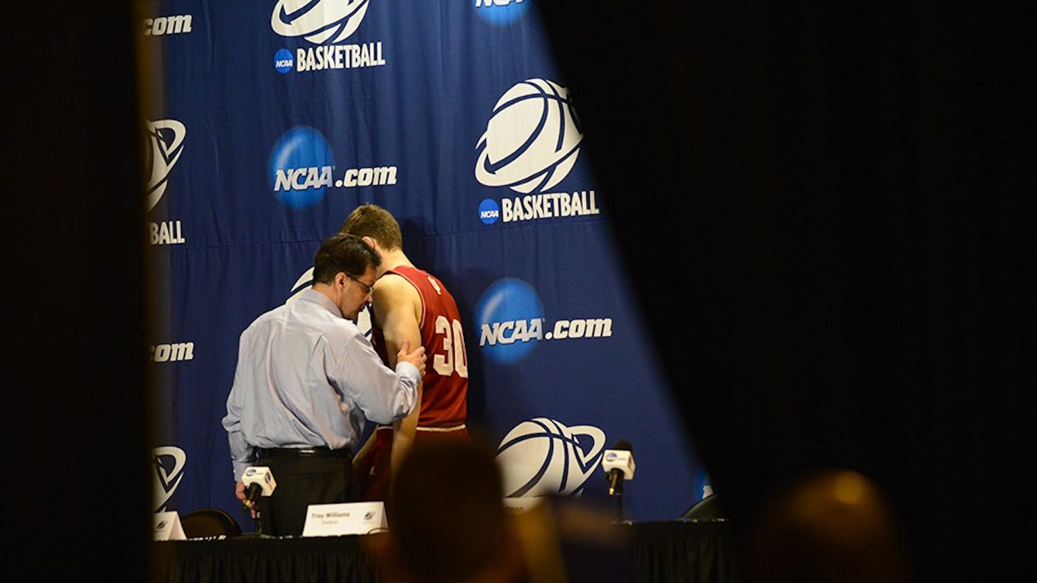 Head coach Tom Crean and sophomore Collin Hartman leave the stage after IU's post game press conference following the 81-76 loss to Wichita State on Friday at the CenturyLink Center in Omaha, Neb.