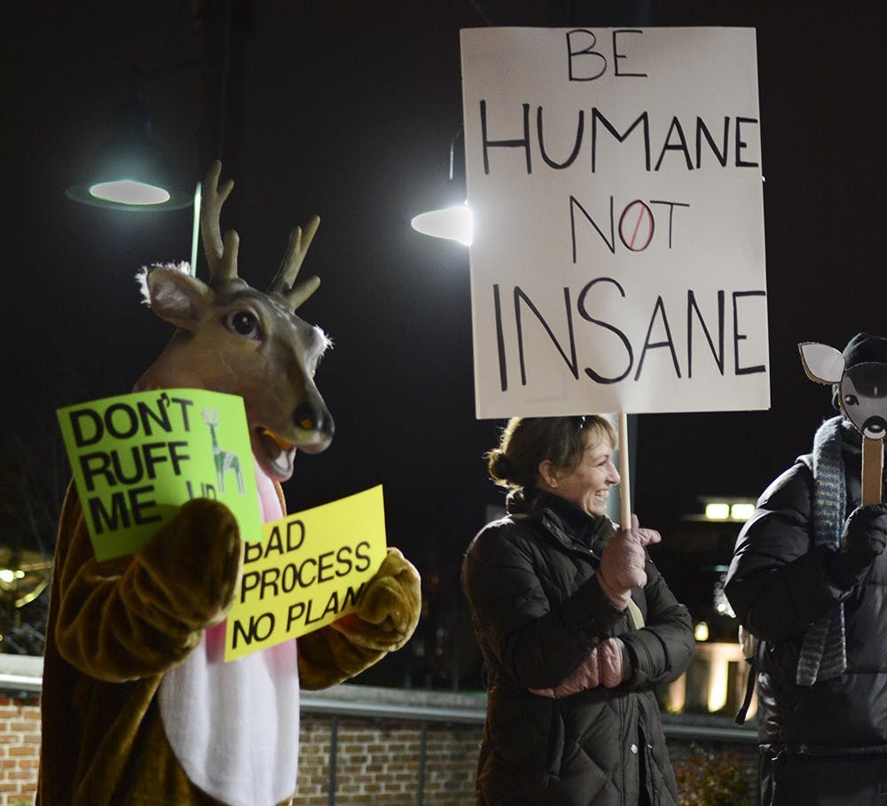 Sandra Shapshay, left, president of Bloomington Advocates for Nonviolent Innovative Deer Stewardship, protests against the deer killing policy in front of Bloomington City Hall on Wednesday.