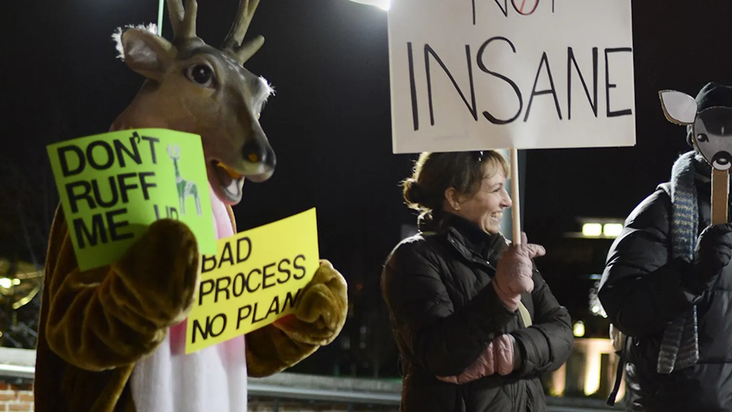 Sandra Shapshay, left, president of Bloomington Advocates for Nonviolent Innovative Deer Stewardship, protests against the deer killing policy in front of Bloomington City Hall on Wednesday.