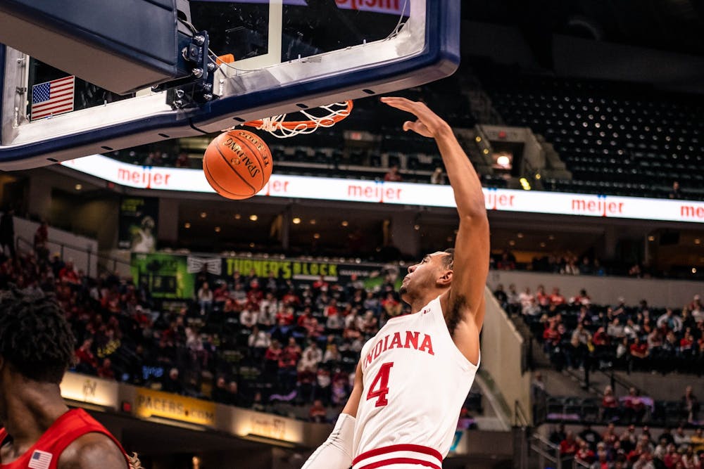 <p>Freshman forward Trayce Jackson-Davis dunks the ball against Nebraska on March 11 at Bankers Life Fieldhouse in Indianapolis. IU was ahead of Nebraska at halftime.</p>
