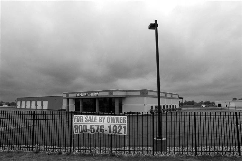 Storm clouds gather over the vacant DeMartini Recreation Vehicle dealership  in Wakarusa, in Elkhart County, Ind., Wednesday, May 13, 2009.  Since the start of the recession in December 2007, Elkhart County, saw the greatest reversal of fortune for counties larger than 25,000 residents. The county's unemployment rate went from 4.7 percent at the start of the recession to 18.8 percent in March.
