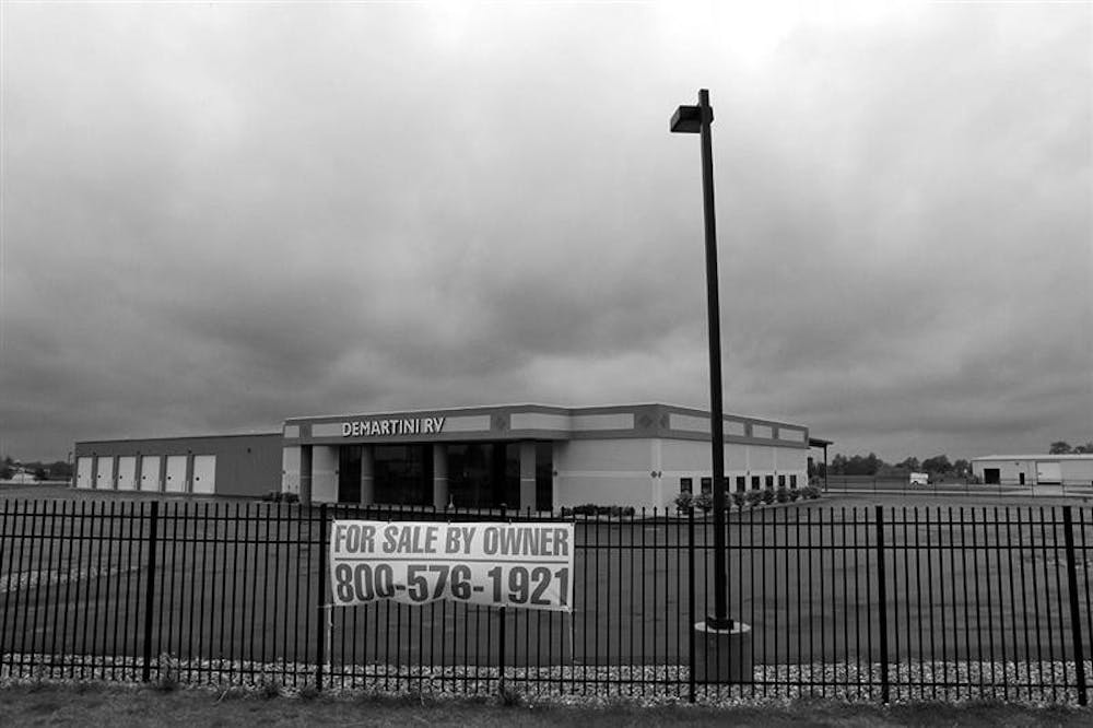 Storm clouds gather over the vacant DeMartini Recreation Vehicle dealership  in Wakarusa, in Elkhart County, Ind., Wednesday, May 13, 2009.  Since the start of the recession in December 2007, Elkhart County, saw the greatest reversal of fortune for counties larger than 25,000 residents. The county's unemployment rate went from 4.7 percent at the start of the recession to 18.8 percent in March.