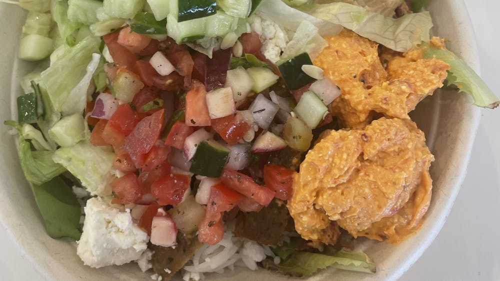 On Sept. 4, Marnie Sara customizes her bowls at Feta Kitchen and Cafe, a restaurant in Bloomington. Feta bowls combine all the distinct flavors of Mediterranean food into one meal. 