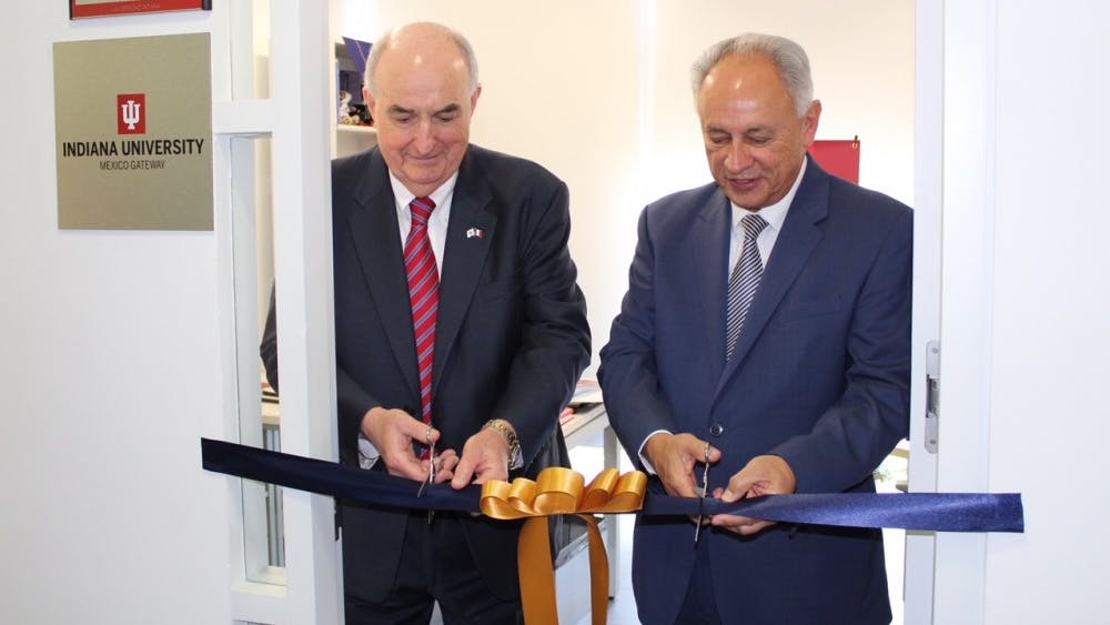 IU President Michael McRobbie, left, and Vice Provost for International Affairs at the National Autonomous University of Mexico (UNAM), Francisco Trigo, right, cut a ribbon at IU's new international Gateway office at UNAM.