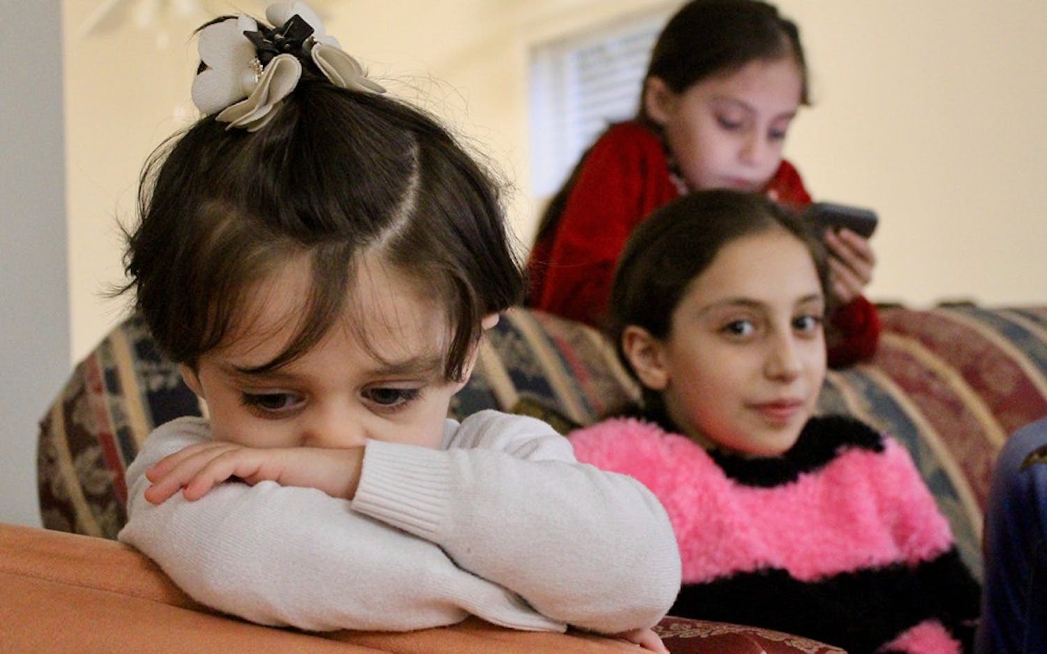 The Lababidi daughters, Remas, 3; Samira, 10; and Sara, 7, relax in the living room of the family's two-bedroom Indianapolis apartment. Samira and Sara have been attending&nbsp;public school despite speaking very limited English.&nbsp;