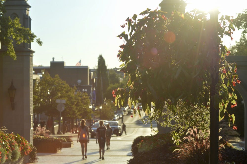 Students exit campus as the sun begins to set on Indiana University's Sample Gates. There have been several books written about IU, including “My First IU Words Go Hoosiers” by Connie McNamara.