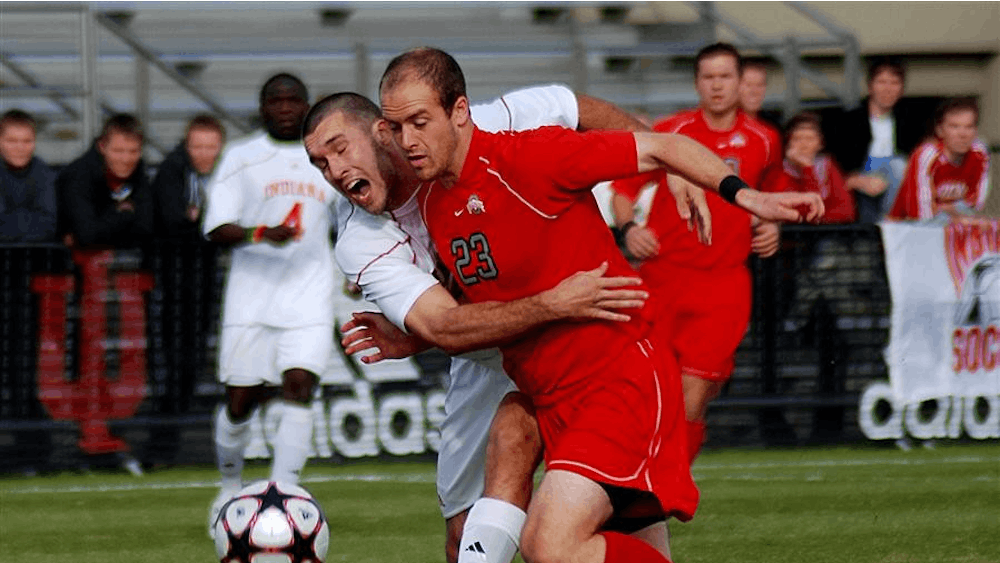 Sophomore forward Will Bruin reaches around Ohio State's David Tiemstra early in the first half of IU's Big Ten semifinal against the Buckeyes on Friday at Bill Armstrong Stadium. Senior forward Andy Adlard scored in the first five minutes, but the Buckeyes responded with three more goals in the first half en route to a 4-2 defeat of the Hoosiers.