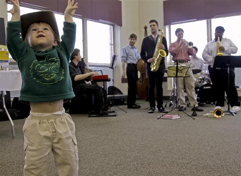 Justice Ulmet, age 21 months, dances while The Haleigh Howe Sixtet performs during the Bloomington Expo on Tuesday evening in the Bloomington Convention Center. In addition to bands providing their flavor, both restaurants and community organizations let residents get a taste of what they're about.