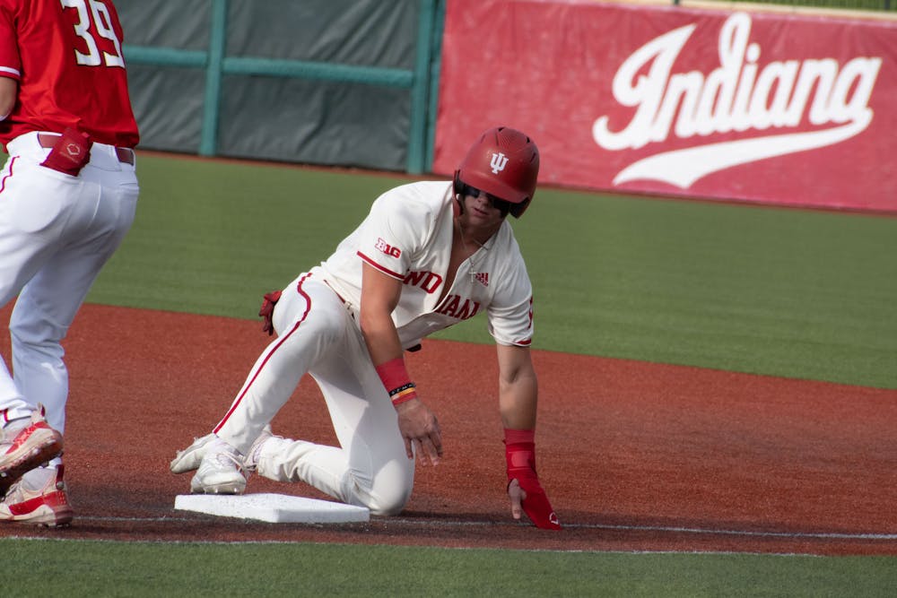 Sophomore designated hitter Carter Mathison slides to first April 28, 2023, against Maryland at Bart Kaufman Field in Bloomington. Indiana swept Northwestern over the weekend.