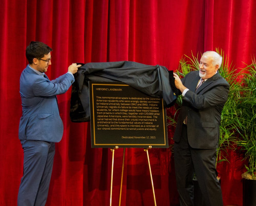 <p>IU alumnus Eric Langowski and John Applegate, Interim Provost and Executive Vice President of the IU Bloomington campus, unveil a plaque describing the treatment of Japanese Americans during World War II on Nov. 12, 2021, at Shreve Auditorium. The ceremony dedicated a Japanese American Ban Memorial to bring awareness to and apologize for IU’s history of denying admission to Japanese American students during World War II. </p><p><br/><br/></p>