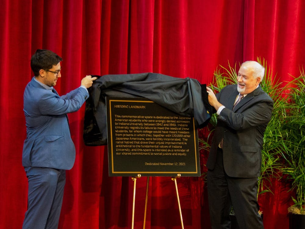 IU alumnus Eric Langowski and John Applegate, Interim Provost and Executive Vice President of the IU Bloomington campus, unveil a plaque describing the treatment of Japanese Americans during World War II on Nov. 12, 2021, at Shreve Auditorium. The ceremony dedicated a Japanese American Ban Memorial to bring awareness to and apologize for IU’s history of denying admission to Japanese American students during World War II. 
