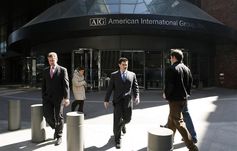 People leave an AIG office building Tuesday, March 17, 2009 in New York. 