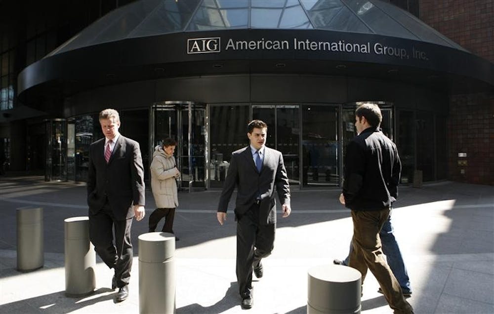 People leave an AIG office building Tuesday, March 17, 2009 in New York. 