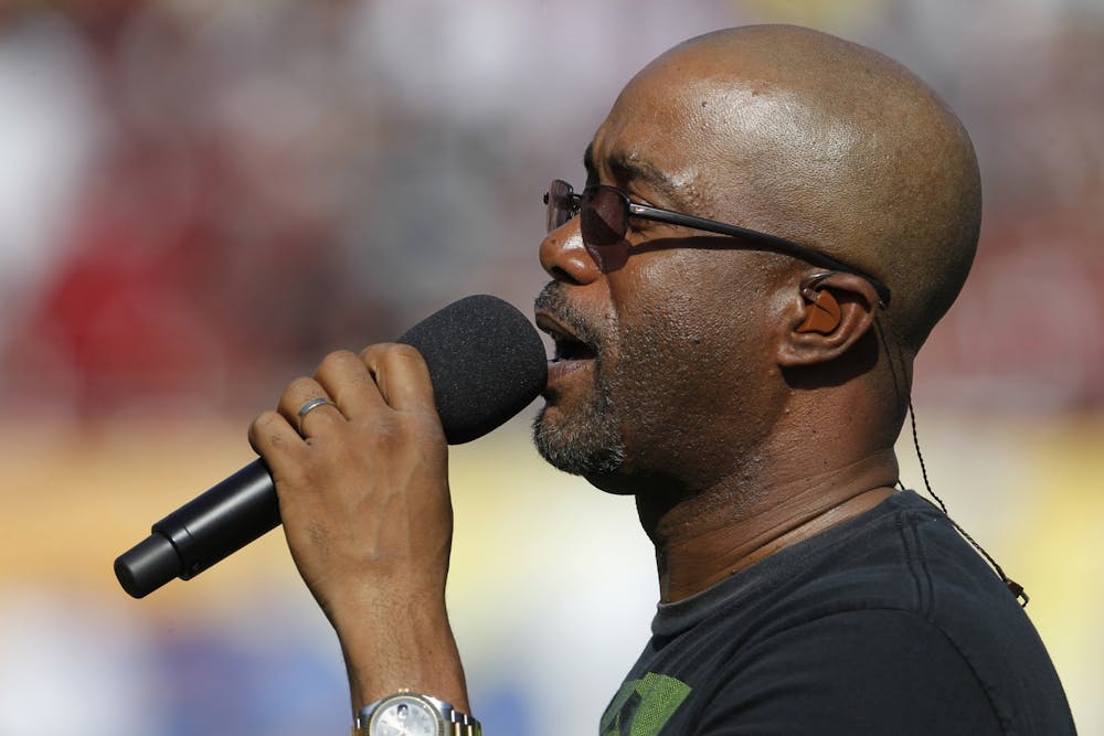 <p>Darius Rucker sings the national anthem prior to the start of the Outback Bowl between University of South Carolina and University of Michigan at Raymond James Stadium in Tampa, Florida, on Jan. 1, 2013. </p>