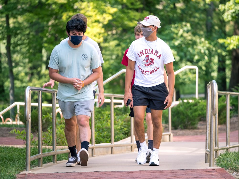 Freshmen students wear masks while walking through IU&#x27;s campus Aug. 24, 2020. Indiana Gov. Eric Holcomb announced March 23 he will end the statewide mask mandate on April 6.