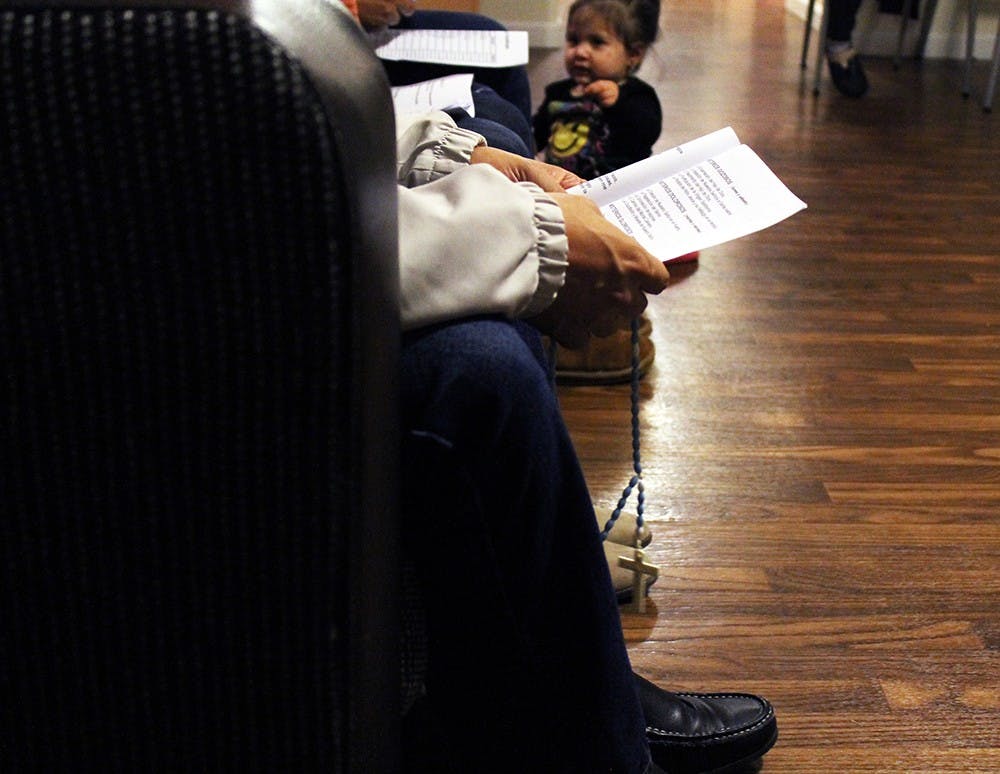 With rosary in hand, Luis Mora prays during a rosary novena on the west side of Bloomington. Rosary novenas were held nightly for 27 days prior to the Day of the Virgin of Guadalupe Dec. 12. 