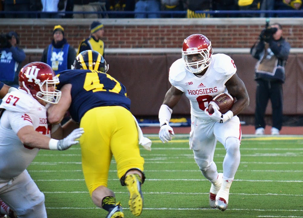 Junior running back Tevin Coleman runs the ball during IU's game against Michigan on Nov. 1 at Michigan Stadium. The IU running backs have stressed not fumbling this season.