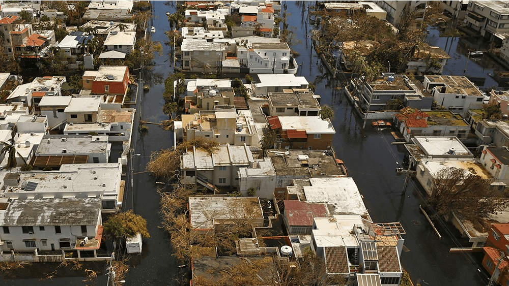 Nearly one week after Hurricane Maria devastated the island of Puerto Rico, residents are still trying to get the basics of food, water, gas and money from banks. Much of the damage done was to electrical wires, fallen trees and flattened vegetation, in addition to wooden home roofs torn off.&nbsp;