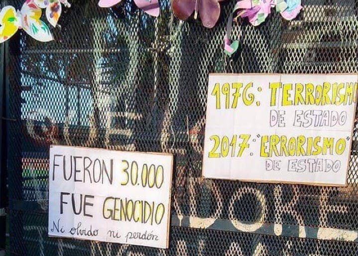 Signs are affixed to a fence in La Plaza de Mayo during a protest on the anniversary of the 1976 military coup. The military government has forcibly disappeared over 36,000 workers and activists.&nbsp;