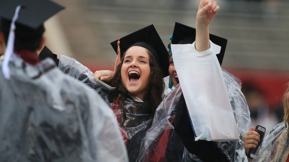 IU graduates shout to their families during the IU graduation ceremony May 4 at Memorial Stadium. A new study found the graduation rate of Indiana college students is rising. 