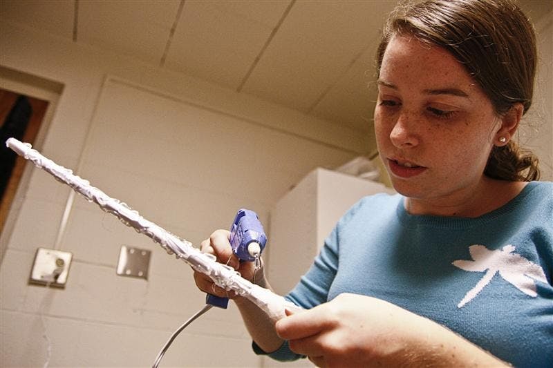 Junior Ashley Carter adds finishing touches to her Harry Potter wand Sunday evening in Collins Brown. Collins is celebrating their third annual Hogwart's Week in celebration of the series.