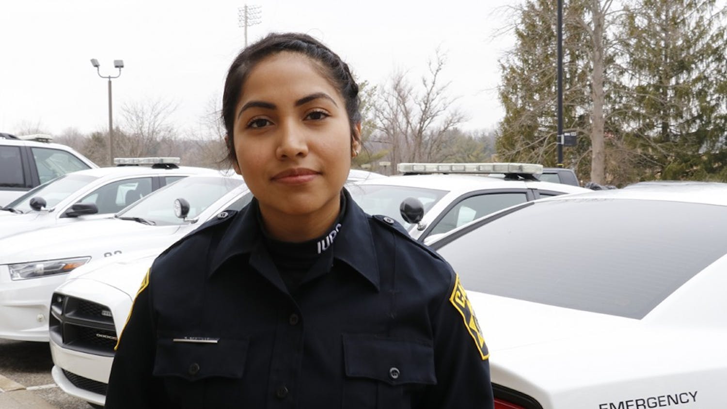 IU Police Department cadet and senior Karla Castillo on her way out of the police department. Cadets meet at IUPD to pick up their radios before starting their security shifts on campus.