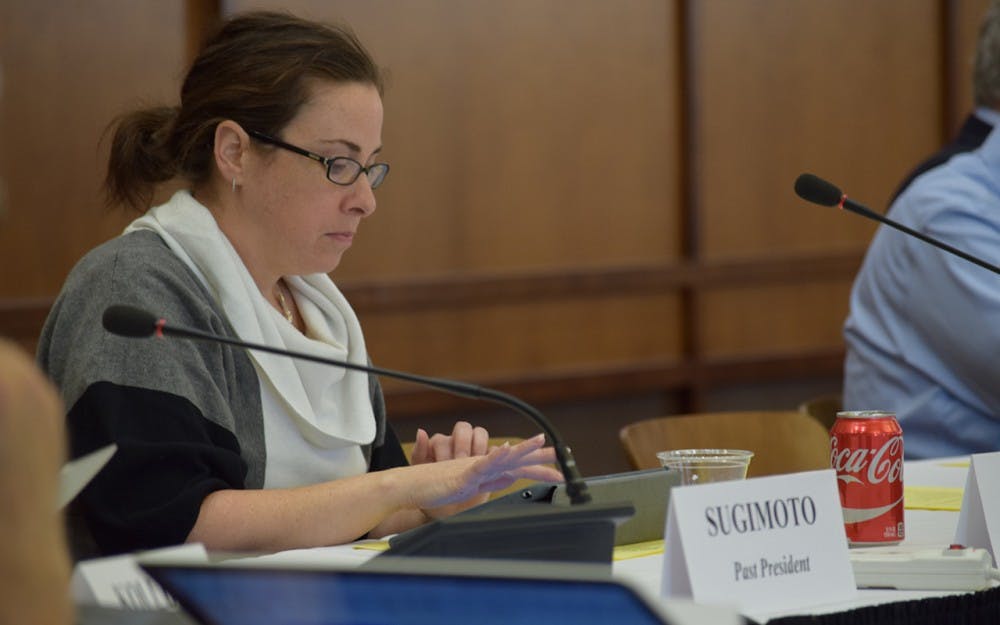 Loria Duggan takes notes on her iPad about the Executive Committee Business.