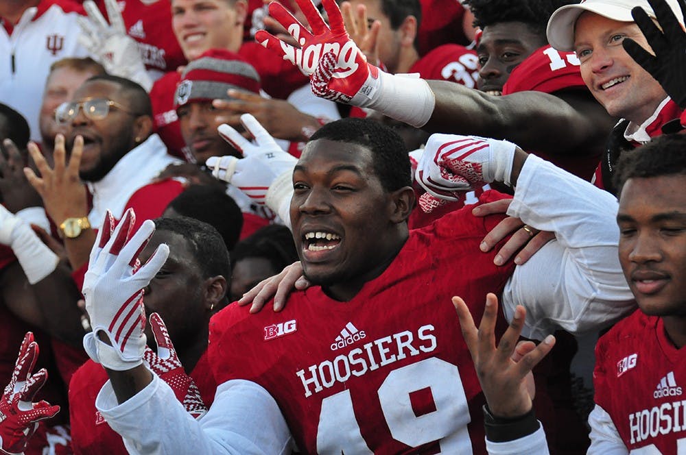 Junior defensive lineman Greg Gooch and his teammates celebrate IU's fourth-straight victory in the old oaken bucket game against Purdue. IU won 26-24 on Saturday at Memorial Stadium.