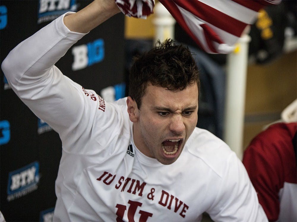 Sophomore Blake Pieroni leads IU in a cheer before the start of the Big Ten Championship meet Saturday evening at the Boilermaker Aquatic Center. Pieroni went on to win the 100-yard freestyle with a time of 42.27, followed closely by junior Anza Tavcar and sophomore Ali Khalafalla who both placed second and third, respectfully.
