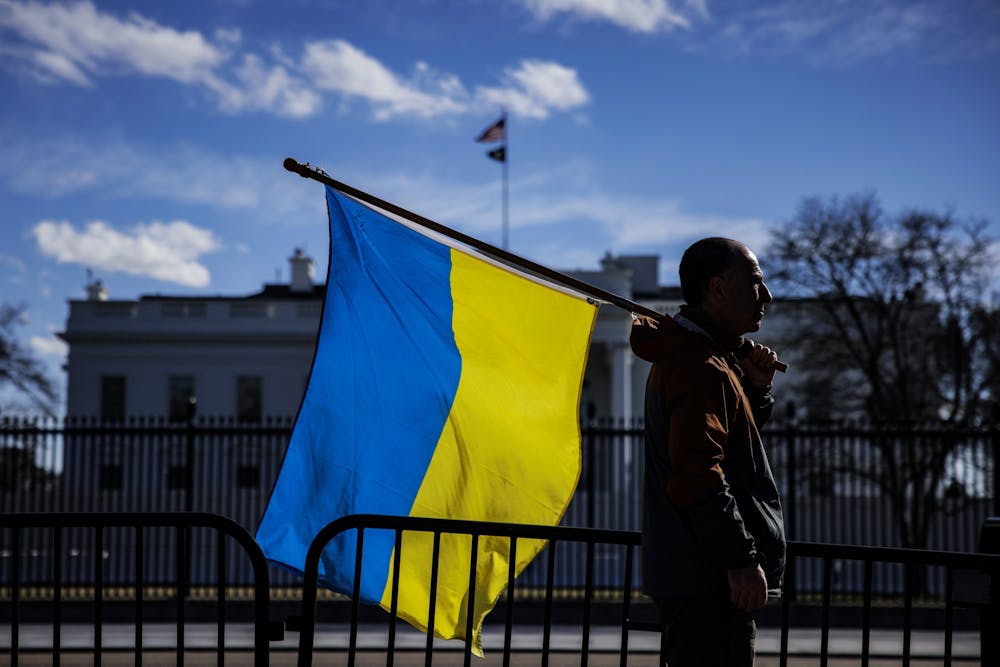 <p>A man holds a Ukrainian flag Feb. 25, 2022, in Washington, DC. IU Provost Rahul Shrivastav announced the university will support 20 humanities and social sciences scholars from Ukraine for one-year nonresidential fellowships, according to an IU news release.</p>