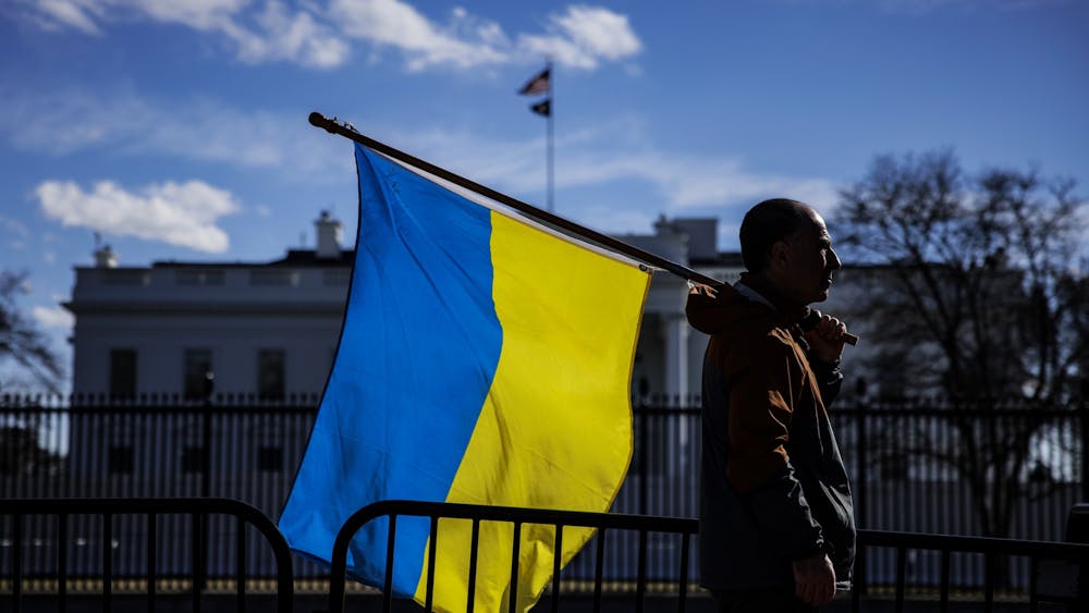 A man holds a Ukrainian flag Feb. 25, 2022, in Washington, DC. IU Provost Rahul Shrivastav announced the university will support 20 humanities and social sciences scholars from Ukraine for one-year nonresidential fellowships, according to an IU news release.