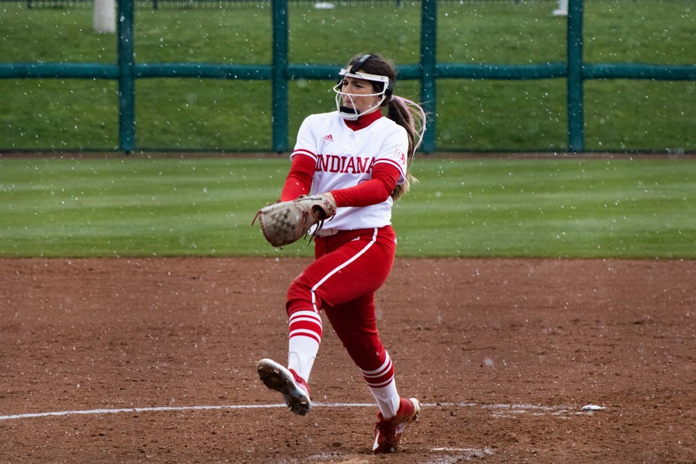 <p>Sophomore pitcher Macy Montgomery throws a pitch in the snow April 8, 2022. Indiana swept Rutgers 3-0 over the weekend to remain undefeated at home this season.<br/></p>