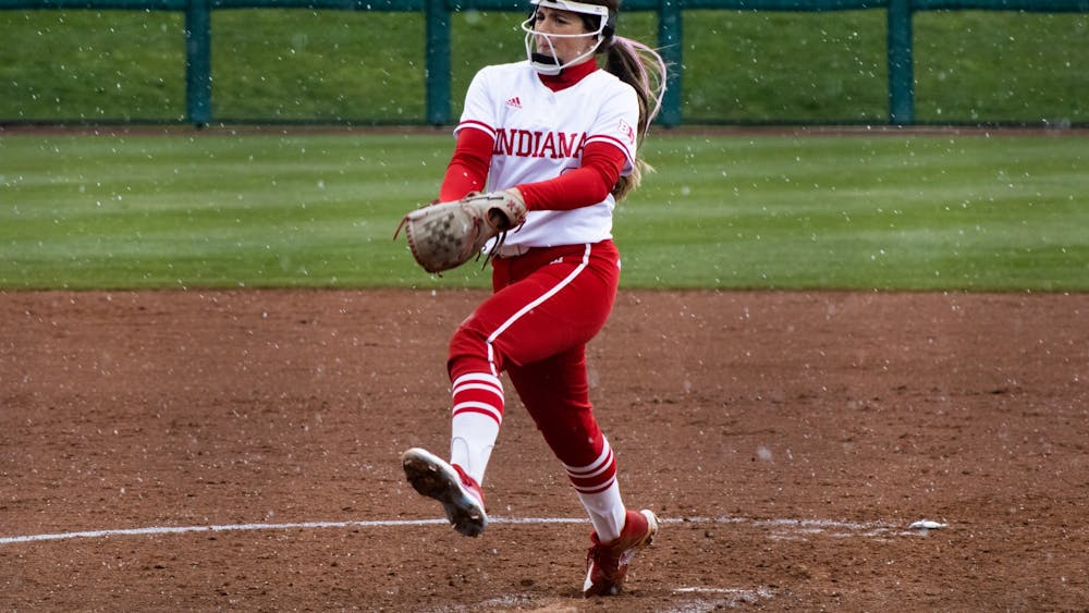 Sophomore pitcher Macy Montgomery throws a pitch in the snow April 8, 2022. Indiana swept Rutgers 3-0 over the weekend to remain undefeated at home this season.