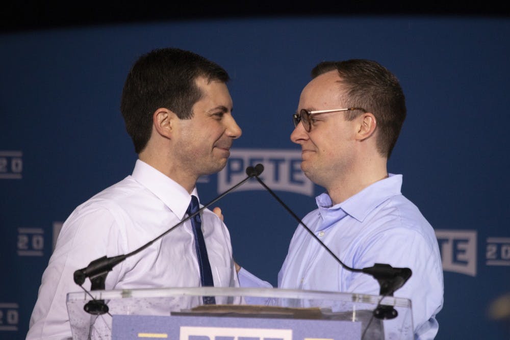 <p>Pete Buttigieg, mayor of South Bend, Indiana, smiles at his husband Chasten on April 14 in Studebaker Building 84 in South Bend, Indiana. Buttigieg and Glezman married in 2018.</p>