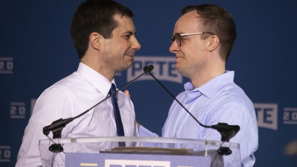Pete Buttigieg, mayor of South Bend, Indiana, smiles at his husband Chasten on April 14 in Studebaker Building 84 in South Bend, Indiana. Buttigieg and Glezman married in 2018.