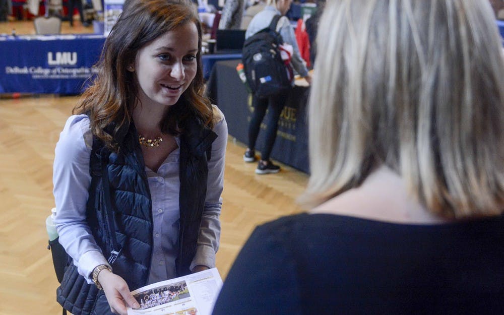 Anna Eschbach, junior majoring in nutritoin science, talks to Jean Shelton, the Director of Admissions and Student Life at Homer Stryker M.D School of Medicine at Western Michigen University, during the Health Program Fair Wednesday afternoon at the IMU. 