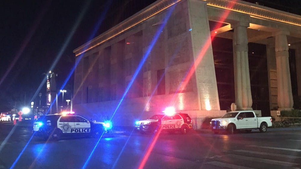 Police vehicles are seen near the site of shooting in Las Vegas on Oct. 2. At least 50 people were killed and over 200 others wounded in a mass shooting at a concert Sunday night outside of the Mandalay Bay Hotel.