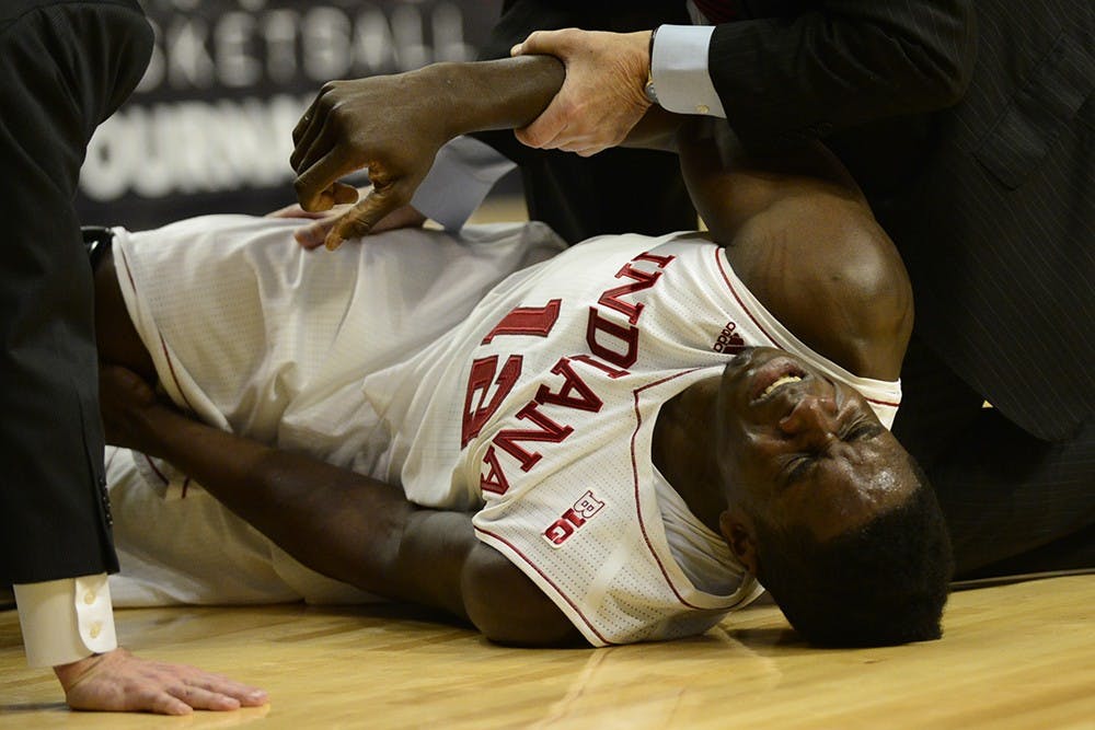 Junior forward Hanner Mosquera-Perea goes down with a knee injury during IU's game against Northwestern on Thursday at the United Center in Chicago, Ill.