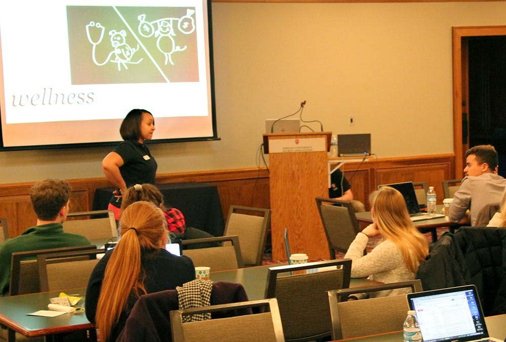 Morgan McMillan, center, member of the MoneySmarts team with the IU Financial Literacy Office, speaks about student debt Wednesday at the DeVault Alumni Center. The event focused on how to be financially responsible after graduation. 